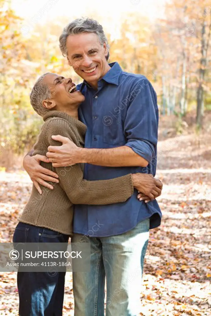 Portrait of mature couple standing on Autumn forest track