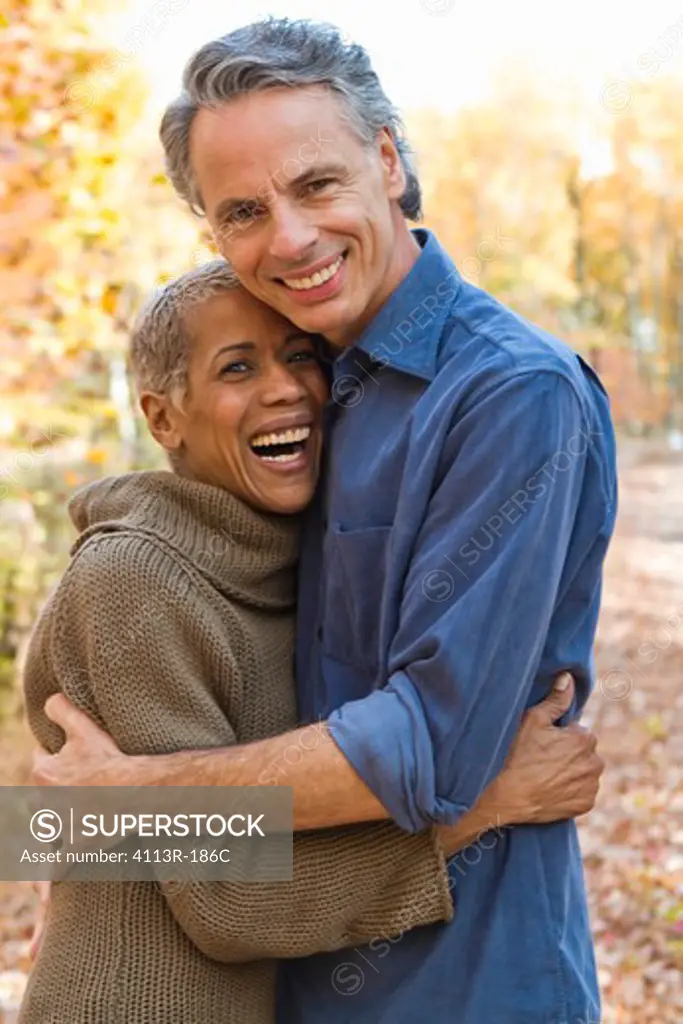 Portrait of mature couple standing on Autumn forest track