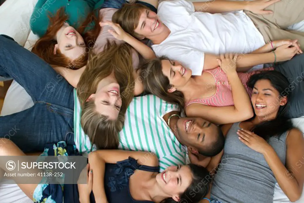 USA, New York City, Manhattan, Group of Teenage friends lying on bed
