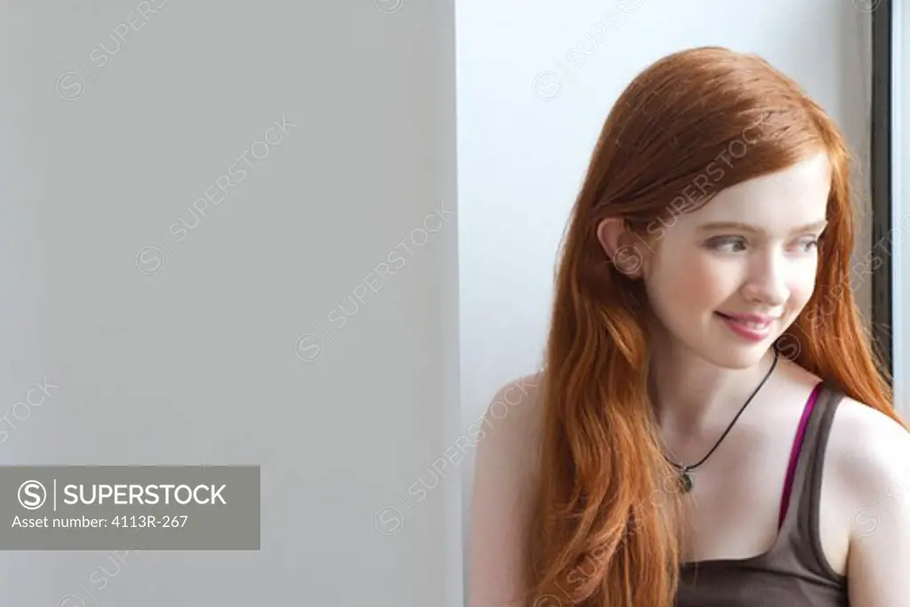 Portrait of girl looking out window