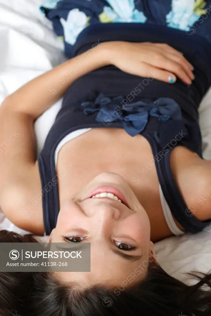 USA, New York City, Manhattan, Portrait of girl lying on bed