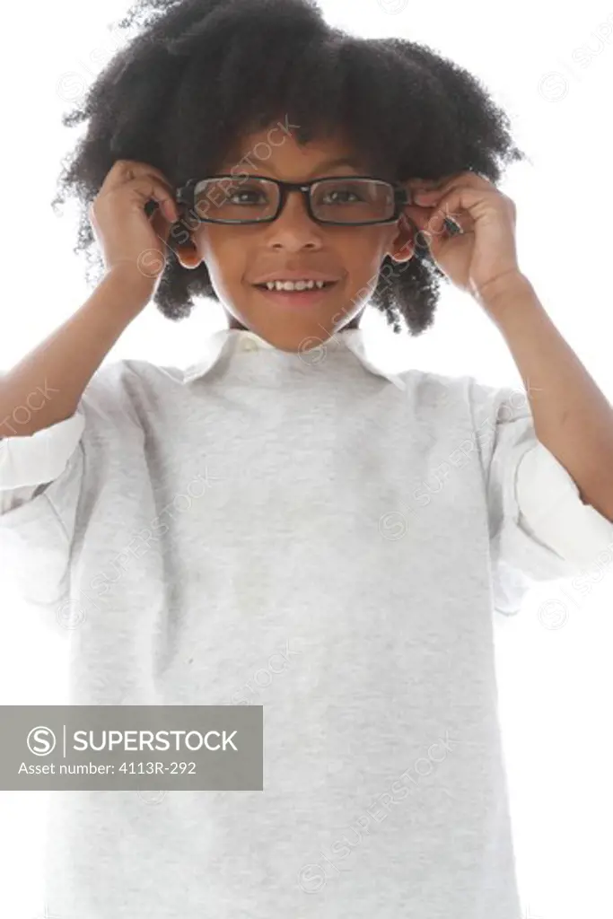 Studio shot portrait of boy with glasses smiling