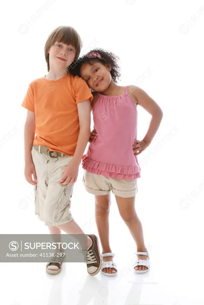 Studio shot of boy and girl standing and leaning on each other