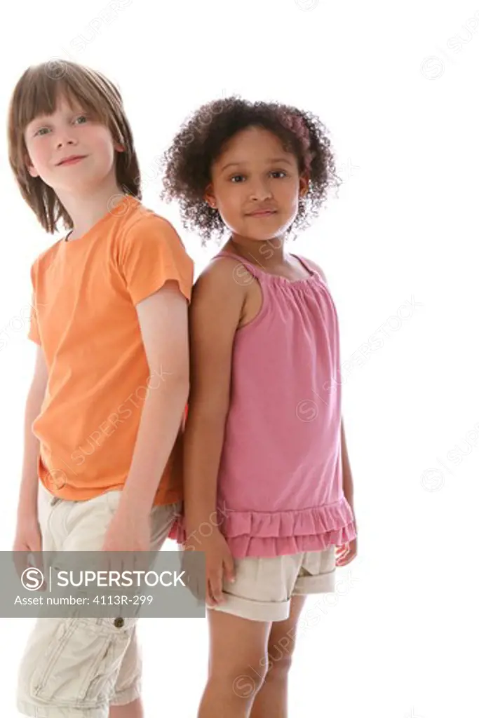 Studio shot of boy standing with girl looking at each other