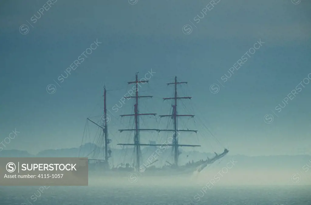 Tall Ship 'Glorida' in fog during the Tall Ships Parade off Boston, Massachusetts, USA.