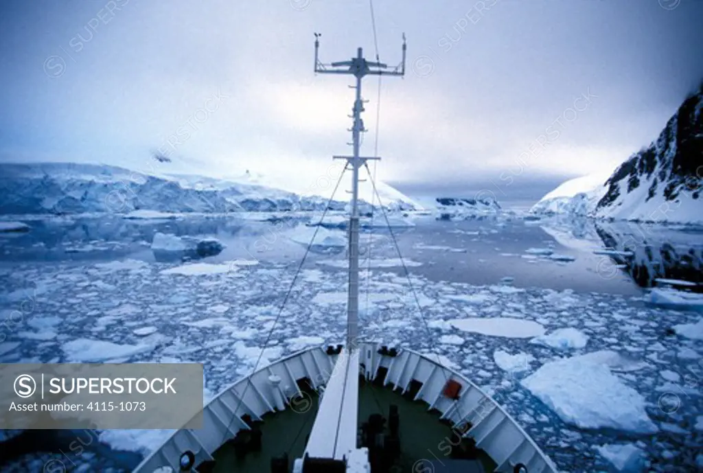 View from the bow of the Russian expedition cruise ship 'Professor Molvanov', making progress through the icy Gerlache Strait, Antarctic Peninsula.