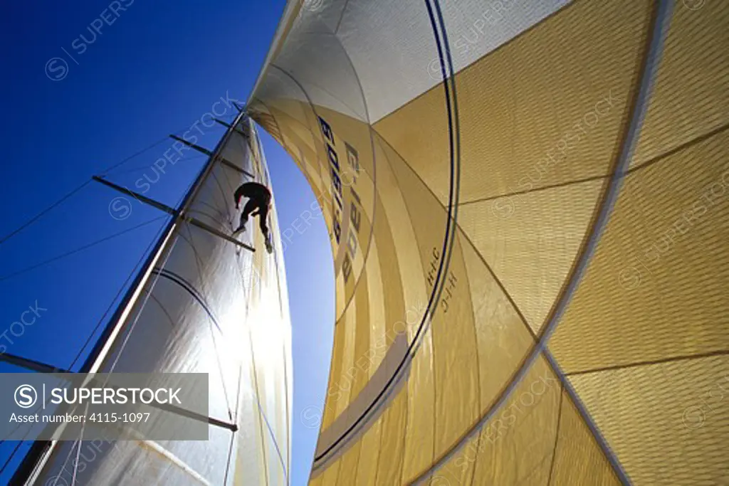 Crew member checking the rigging aboard a race yacht.