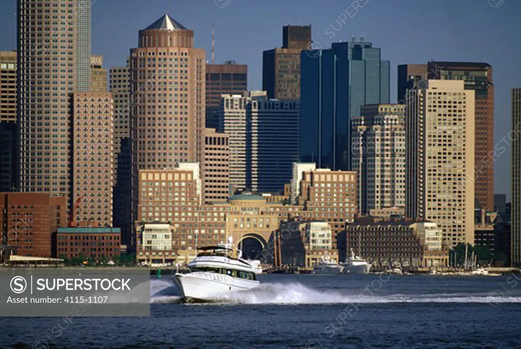 Powerboat with skyscrapers in the background, Boston Harbour near Rose Wharf, USA.