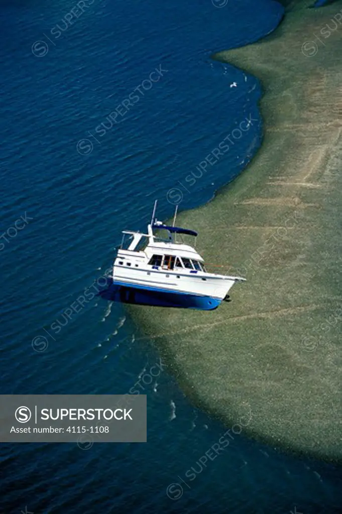 Motorboat aground on a sand bar at low tide, Cape Cod, USA.