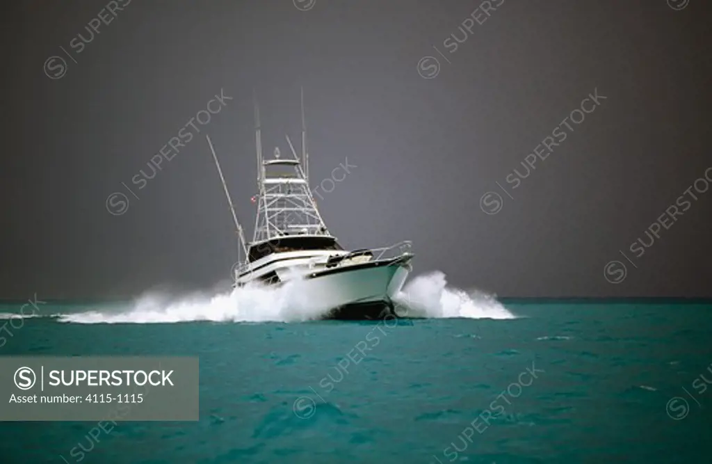 Sport fishing boat heading home with storm clouds approaching.