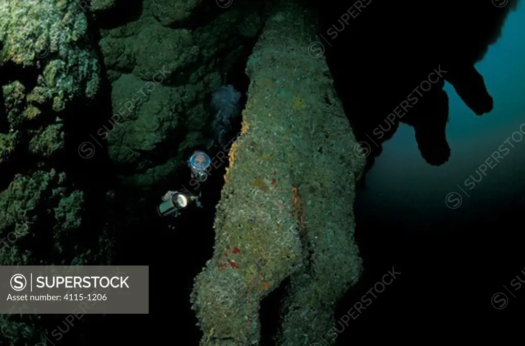 Scuba diving at the Blue Hole dive site, a perfectly circular limestone sinkhole with stalactites and limestone formations, Lighthouse Reef System, Belize