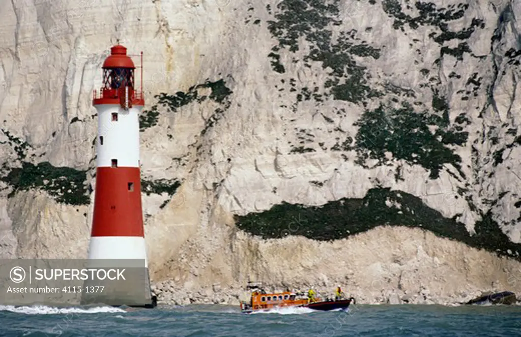 Eastbourne Lifeboat passes the Beachy Head Lighthouse. Beachy Head rises 162 metres (530 feet) above the sea below and is the highest chalk sea cliff in Britain, this is the most famous part of the Eastbourne downlands.