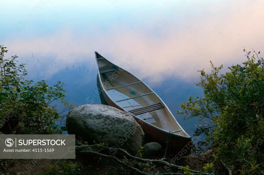 A kayak floating in the misty early morning light on Lake Dennison, Massachusetts, USA.