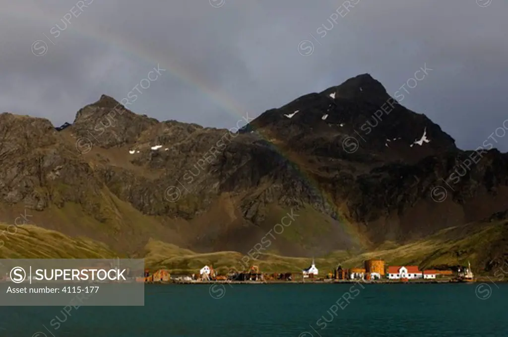 A rainbow arcs over the old whaling station of Grytviken in King Edward Cove, South Georgia, February 2007.