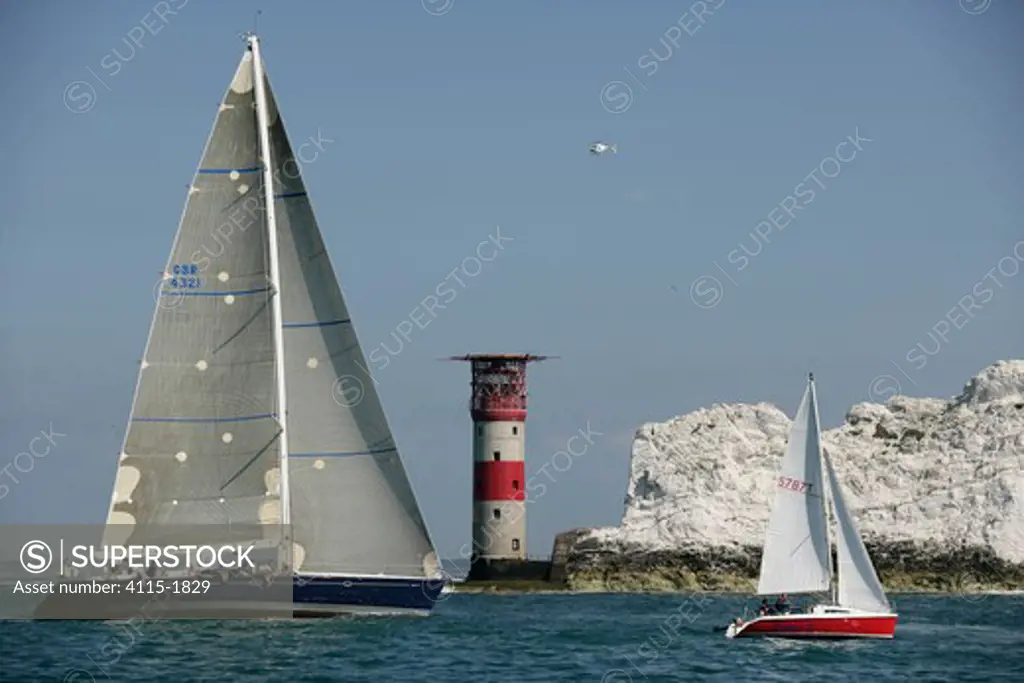 Maxi-superyacht 'Oystercatcher XXV' racing in the JPMorgan Round the Island Race, with The Needles Lighthouse in the background, Isle of Wight, England, UK, 18th June 2005.