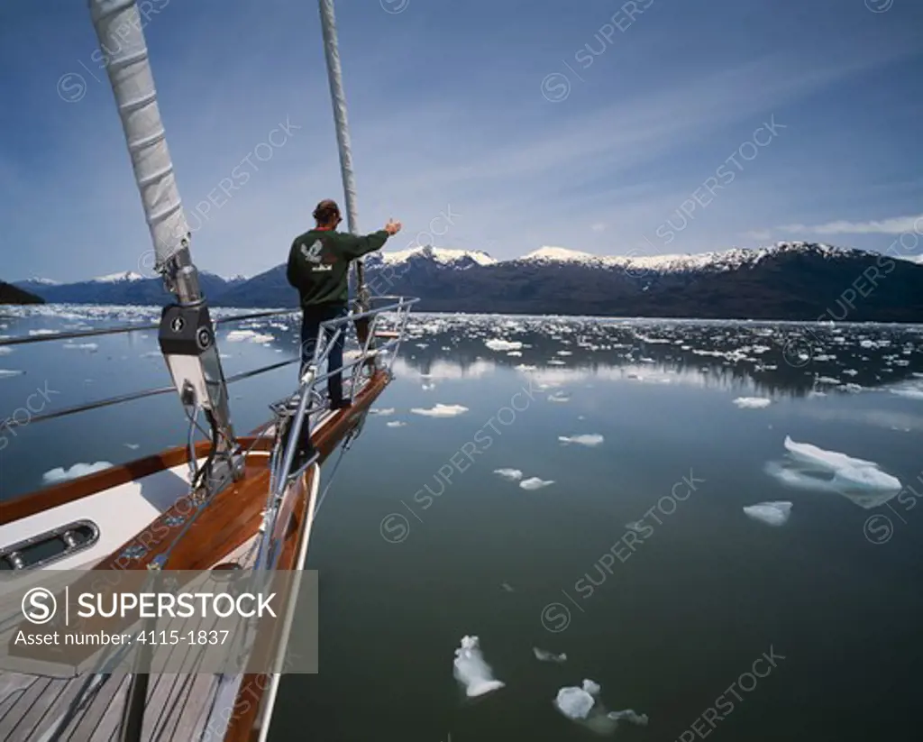 The superyacht 'Sariyah' with bowman on bowsprit pointing the course, exploring the southern fjords of Chile.
