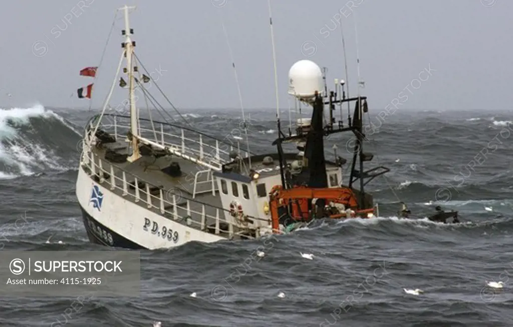 MFV 'Demares' heaving up trawl warps in moderate sea swells, North Sea. October 2006.