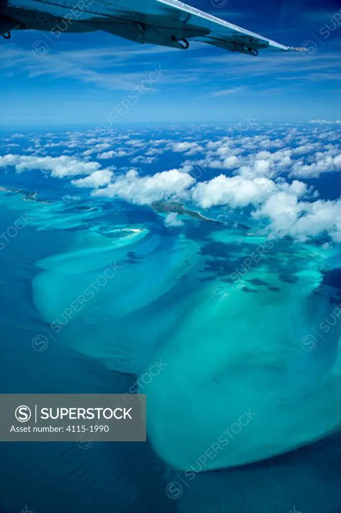 Aerial view with aeroplane wing and clouds, of Exuma, part of the chain of 365 islands that form the Bahamas.