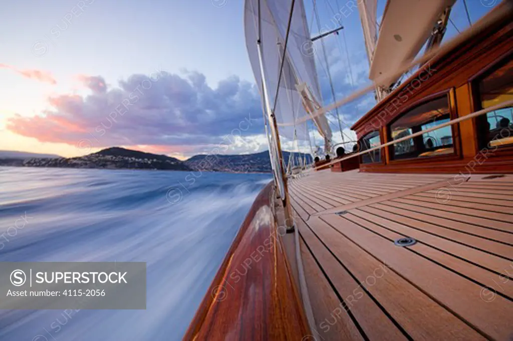 The water moving quickly past the rail of 140ft luxury schooner 'Skylge', sailing in the French Riviera, France