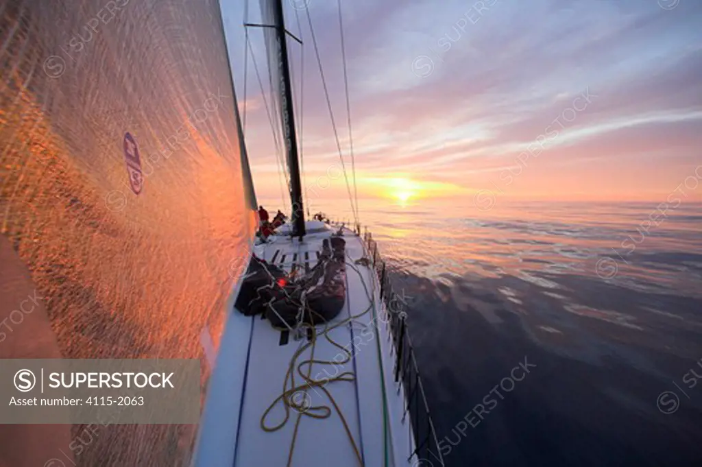 The orange sunrise reflecting on the head sail of 'Maximus'  during the 2006 Newport to Bermuda race