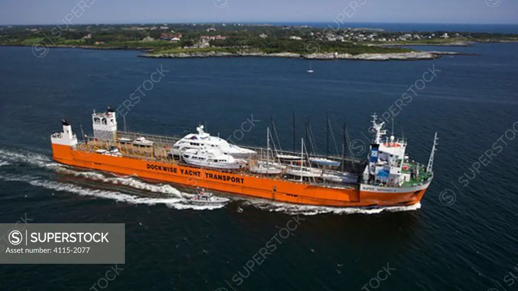 Yacht transport ship leaving port, accompanied by a pilot vessel. Newport, Rhode Island