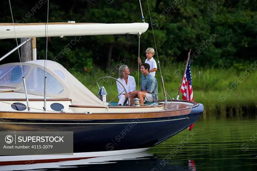 Family on the stern of a Friendship 40 cruising yacht, Rhode Island.
