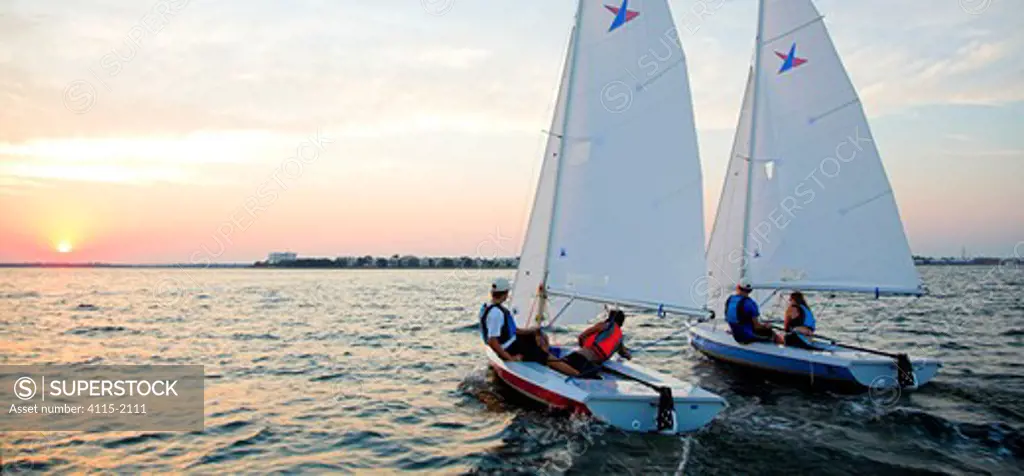 Vanguard V15 dinghy sailing at sunset, Charleston, South Carolina, USA