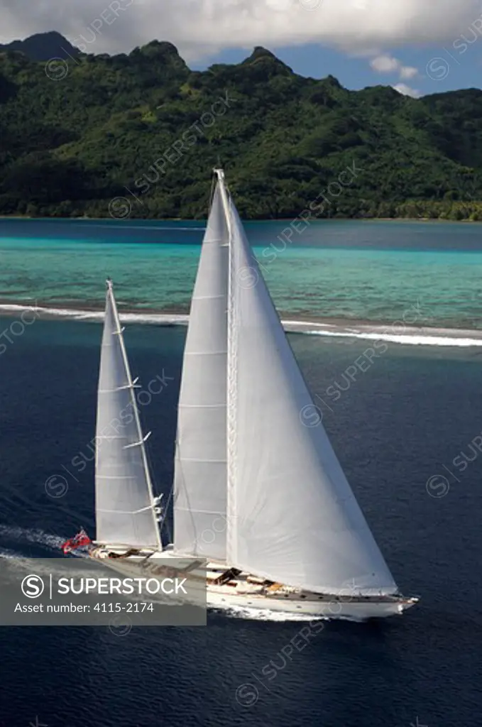 Aerial view of SY 'Adele', 180 foot Hoek Design, underway close to the reef off Huahine Island, French Polynesia, 2006.