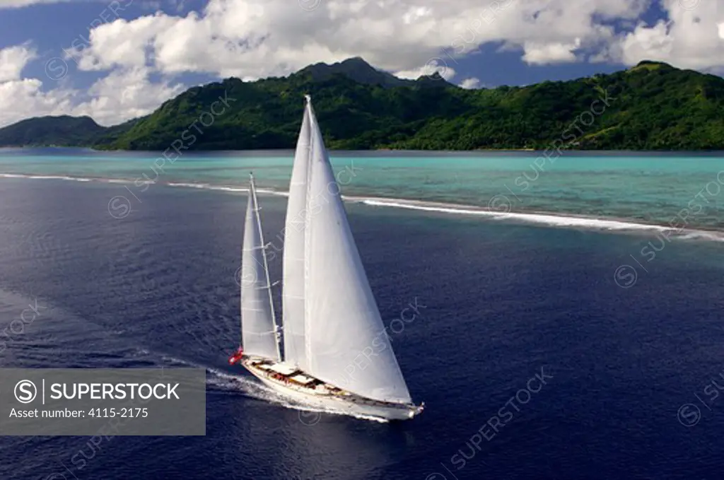 Aerial view of SY 'Adele', 180 foot Hoek Design, underway close to the reef off Huahine Island, French Polynesia, 2006.