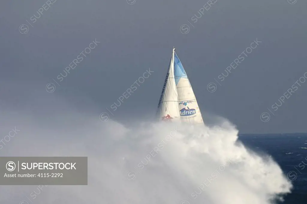 Jean Luc van den Heede arriving at Oessant (Ushant) in a cloud of spray, after record circumnavigation of 122 days, 14 hours, 3 minutes and 49 seconds. Global Challenge, March 2004