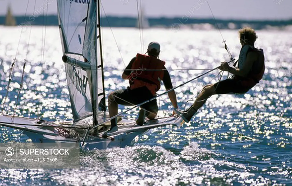 49er dinghy crew trapezing on silvery waters