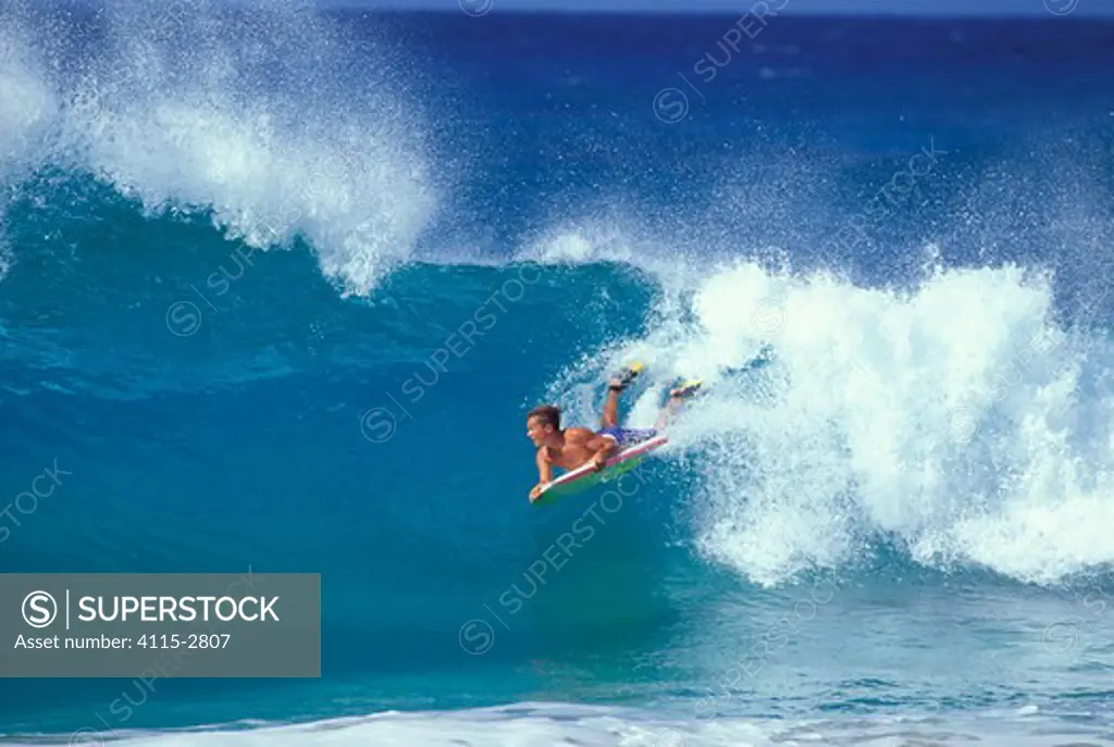 A bodyboarder catches a wave in Hawaii