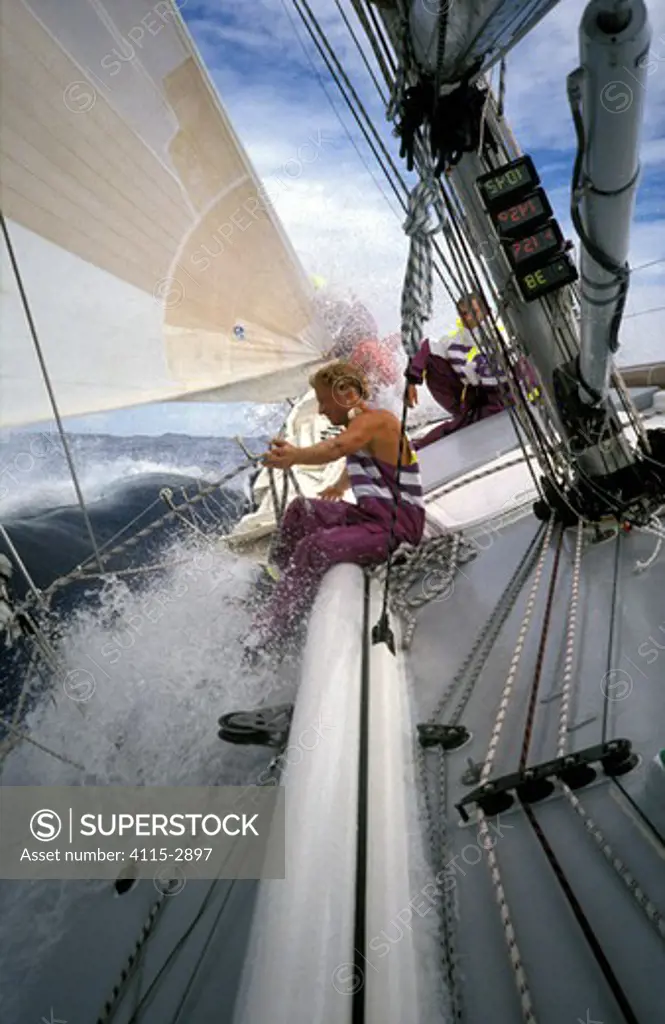 Crew on the bow of 'The Card' during the Whitbread Round the World Race, 1989-90.