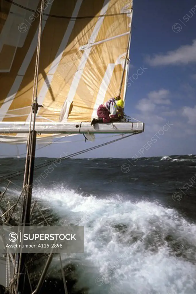 Crew on the boom aboard 'The Card' during the Whitbread Round the World Race, 1989-90.
