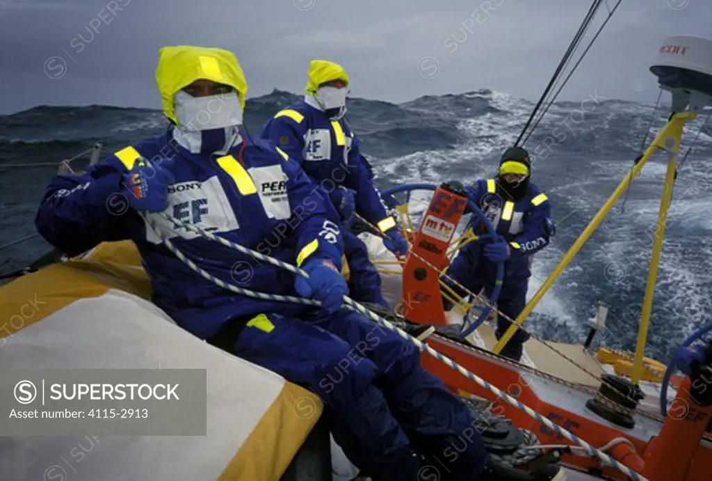 Crew on 'EF Language' wear full heavy weather clothing, competing in the Whitbread Round the World Race, 1997-1998.