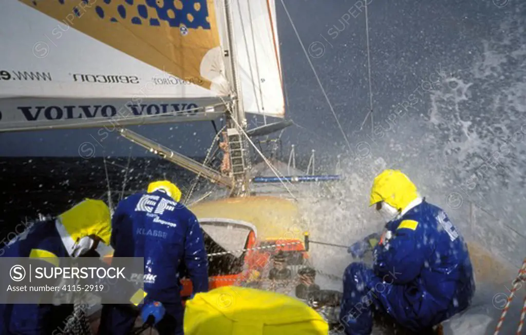 Crew aboard 'EF Language' wear full heavy weather clothing while racing during the Whitbread Round the World Race, 1997-1998.