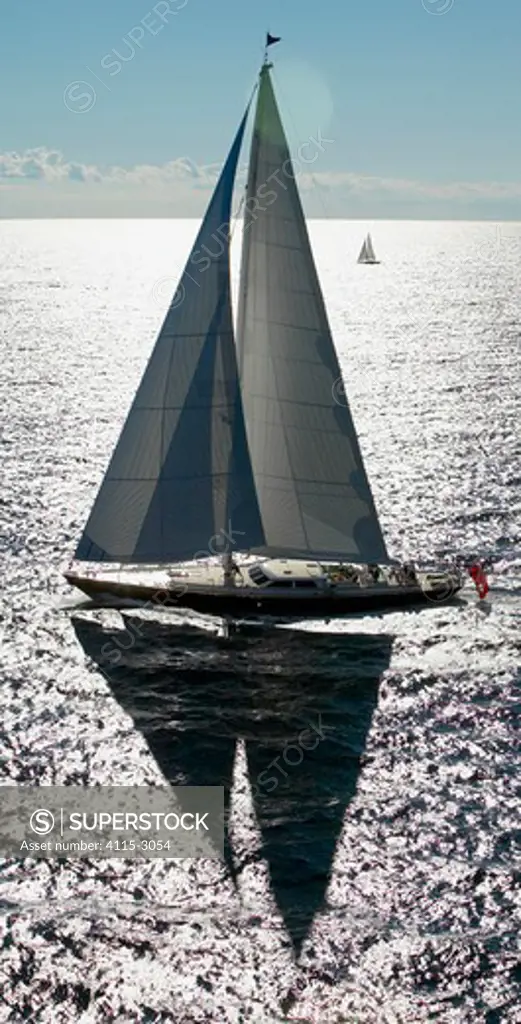 116ft Ted Hood designed superyacht 'Whisper' sails past the distant 'Black Tie'.