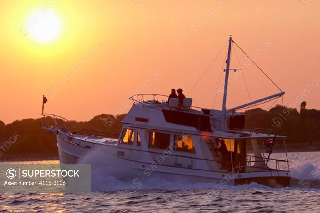 Grand Banks motoryacht cruising into the sunset.