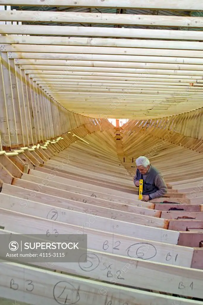 Shipwright at work during construction of a 38-metre wooden motorboat, at a boatbuilders in Fiumicino, Rome.