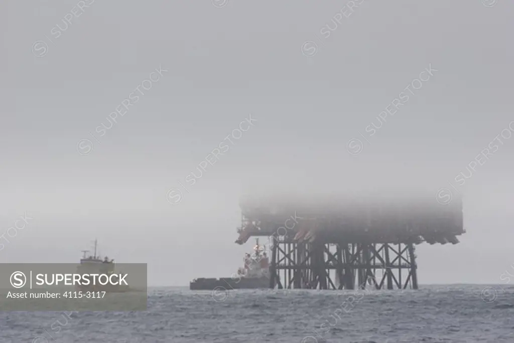 Piper oil field with ships in foggy conditions, North Sea. March 2005.