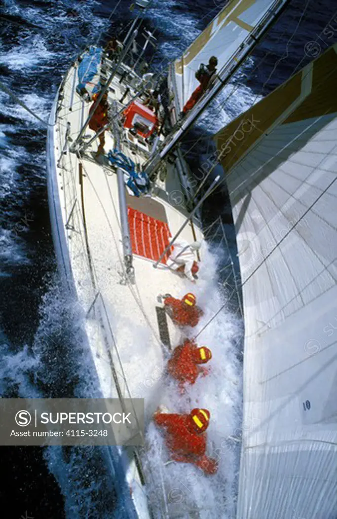 Four crew prepare for a sail change on 'Drum' during the Whitbread Round the World Race, 1985-6.
