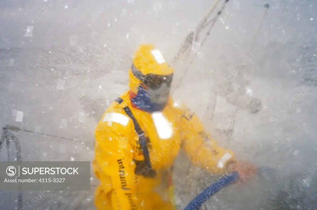 Helmsman on 'Intrum Justitia' is geared up in waterproofs and goggles as they move through the Southern Ocean in the Whitbread Round the World Race, 1993.