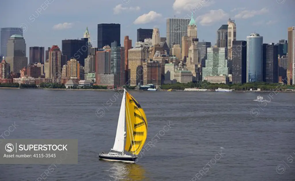 Aerial view of a sailing yacht in front of New York City, New York harbour, USA.