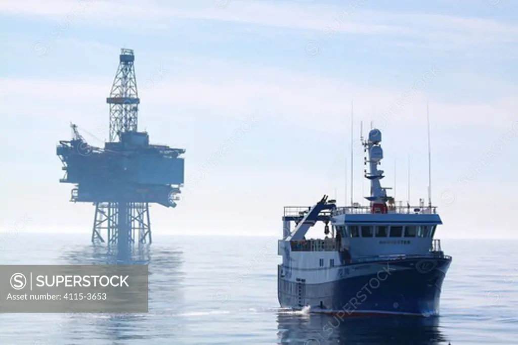 Fishing vessel 'Harvester' and the 'Jotun B' oil production platform. North Sea, May 2010.