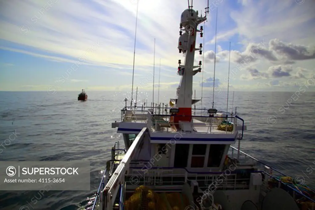 Fishing vessel 'Vela' viewed from aboard 'Harvester', trawling in calm conditions on the North Sea, May 2010.