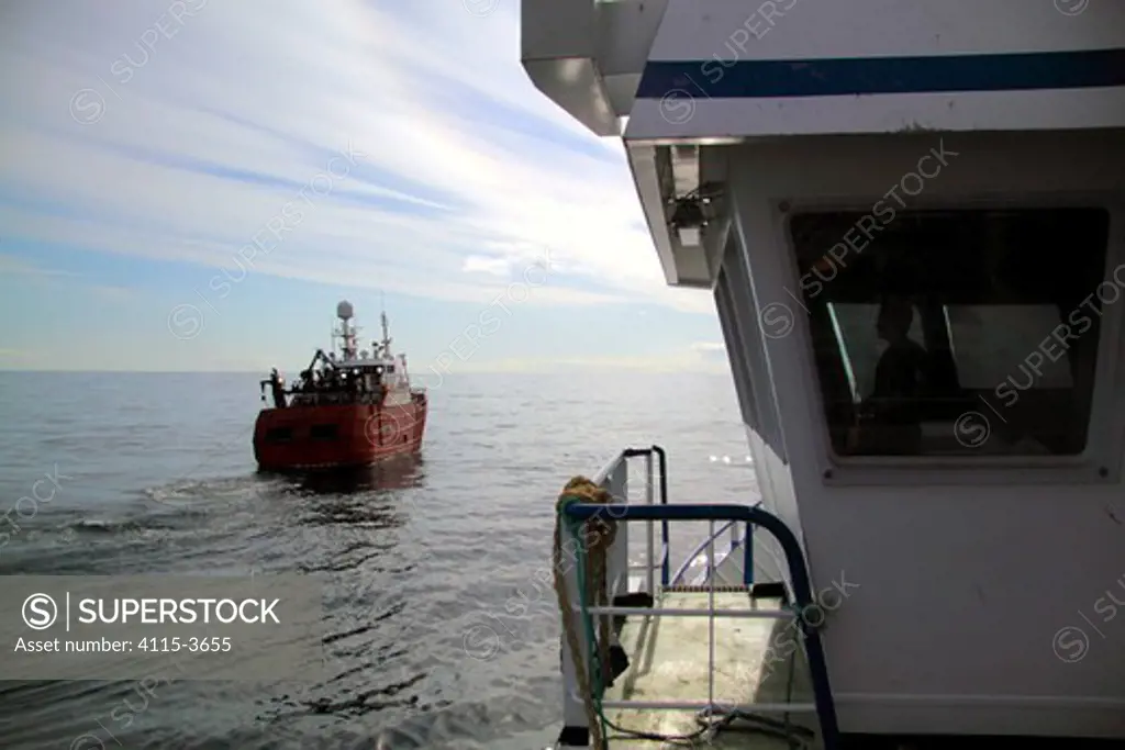 Fishing vessel 'Vela' viewed from aboard 'Harvester', trawling in calm conditions on the North Sea, May 2010.