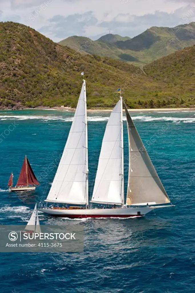 Two smaller yachts flanking schooner 'Windrose' at the Panerai Antigua Classic Yacht Regatta, Caribbean, April 2010.