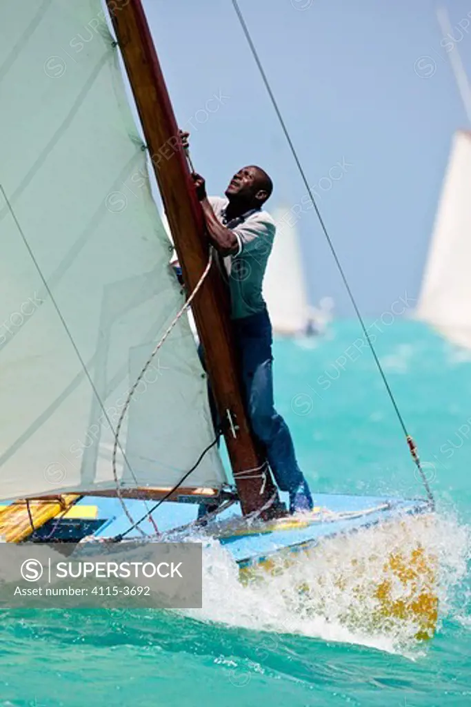 Working the mainsail during the Bahamian Sloop regatta, Georgetown, Exumas, Bahamas. April 2009.
