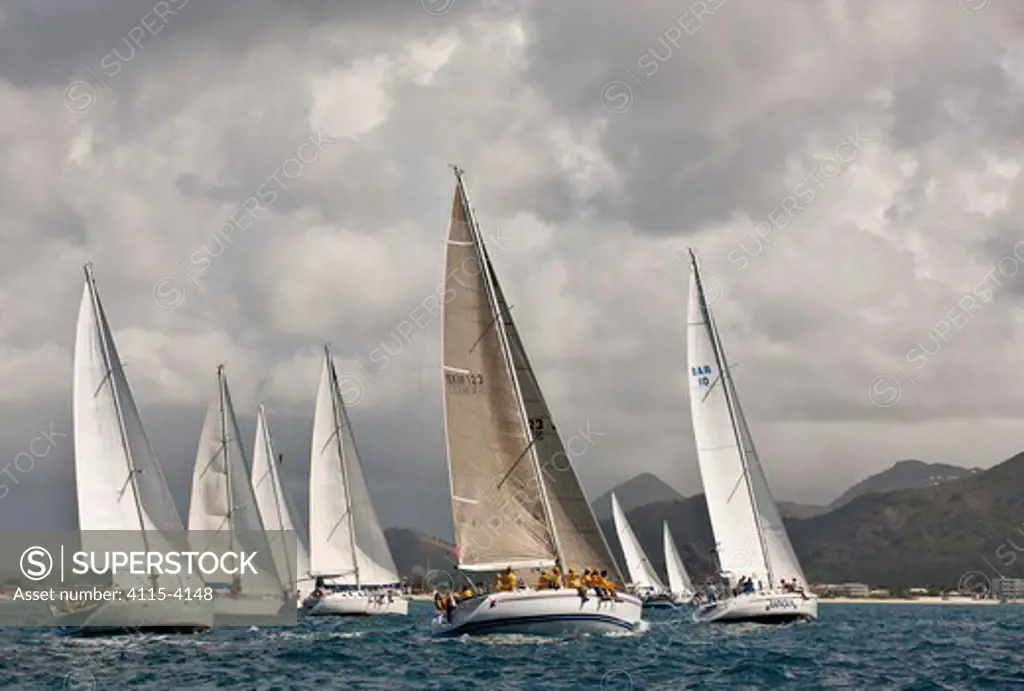 Fleet racing beneath stormy skies during the Heineken Regatta, St Martin, Caribbean, March 2011.