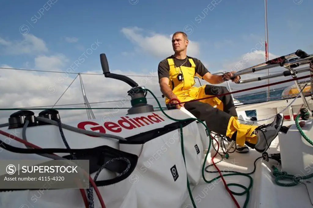 Skipper Thierry Chabagny helming on board 'Gedimat' ahead of La Solitaire du Figaro, Concarneau, France, July 2011. All non-editorial uses must be cleared individually.
